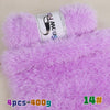 Purple chunky faux fur yarn in a skein with a purple knitted item visible.