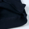 A close-up view of a black ribbed kids pullover hoodie.
