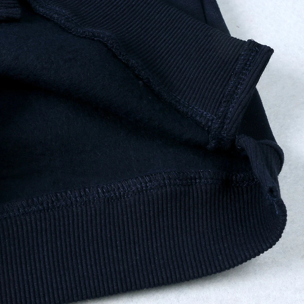 A close-up view of a black ribbed kids pullover hoodie.