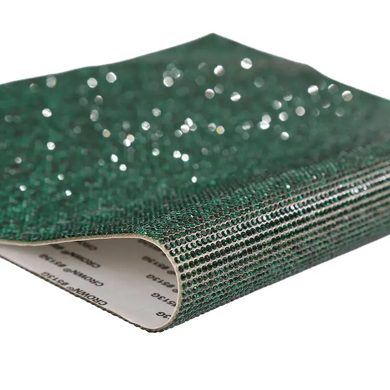 Green sparkling rhinestone adhesive tape rolled up for DIY crafts and decor
