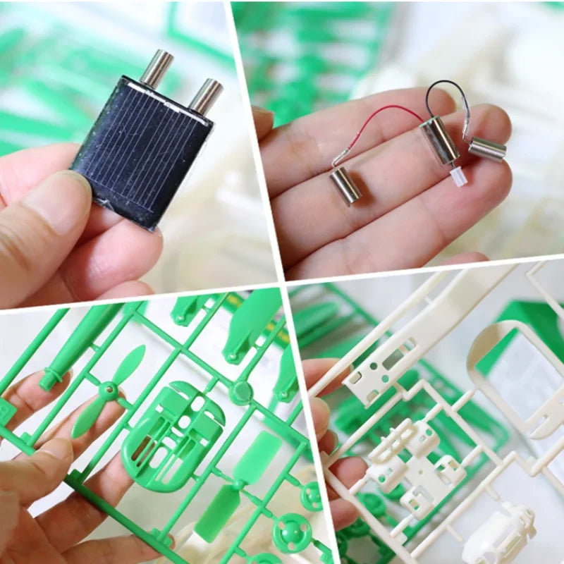 A hand holds a black solar robot kit with attached wires and components, alongside green plastic parts and a white frame.