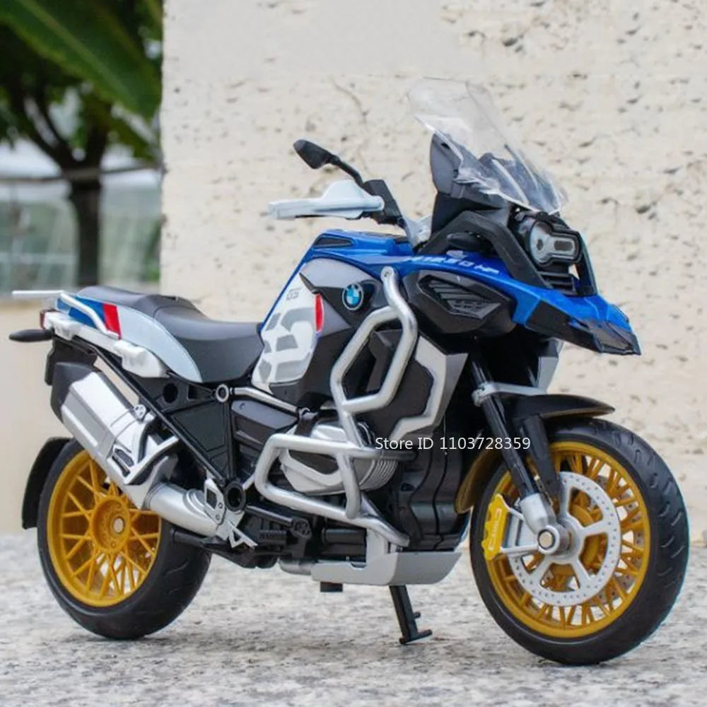 A blue and black BMW motorcycle diecast model with lights and suspension on a gray surface.
