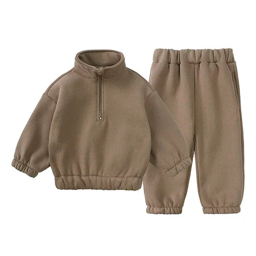 A tan fleece hooded tracksuit set for a child, consisting of a zip-up top and matching pants.