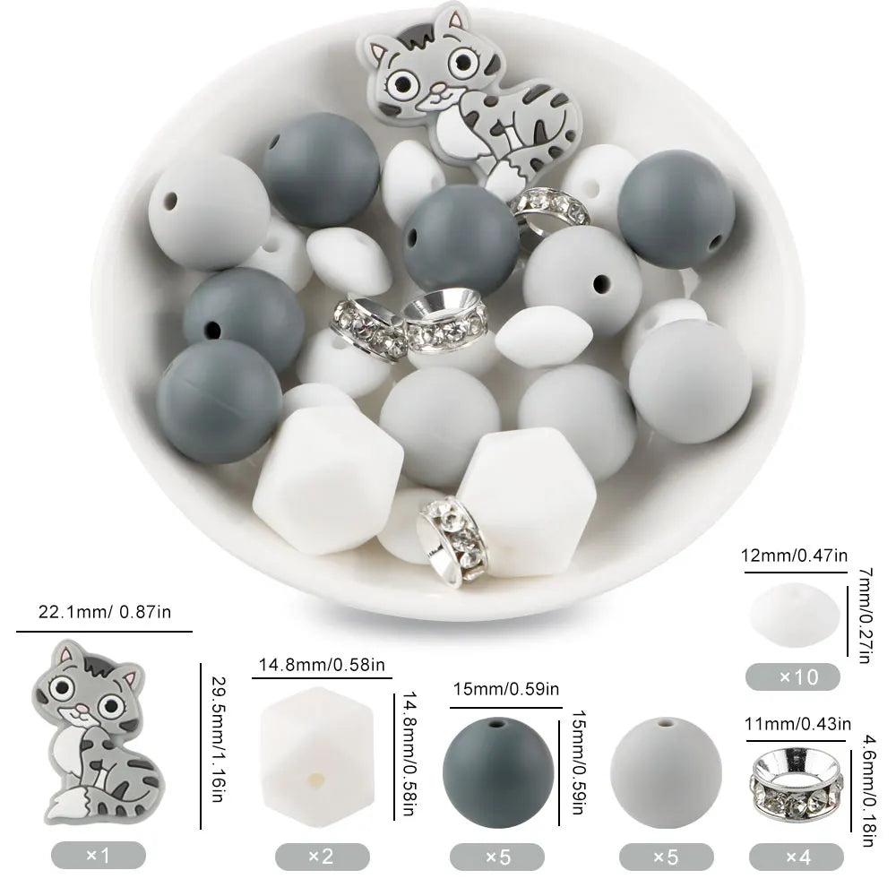 A white bowl filled with various gray and white silicone beads shaped like cartoon animals for DIY jewelry making