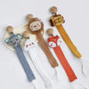 A collection of elephant pacifier holders featuring various animal designs like a lion and fox