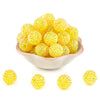 A pile of bright yellow rhinestone resin bayberry beads for jewelry making