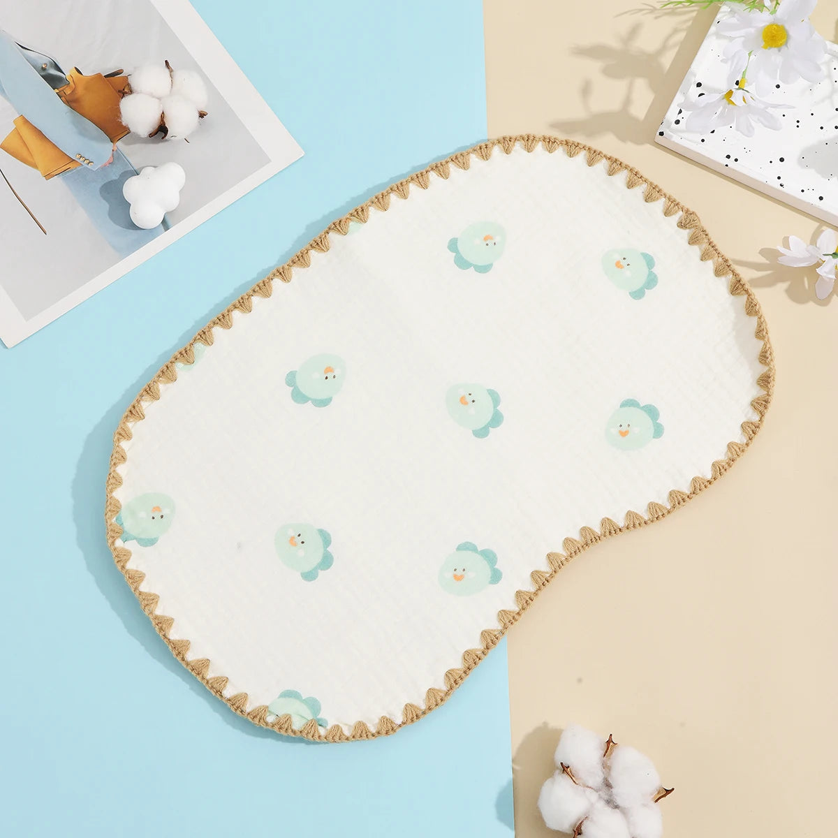 A white 10-layer cotton gauze flat pillow with light green embroidered cloud shapes resting on a pale background.