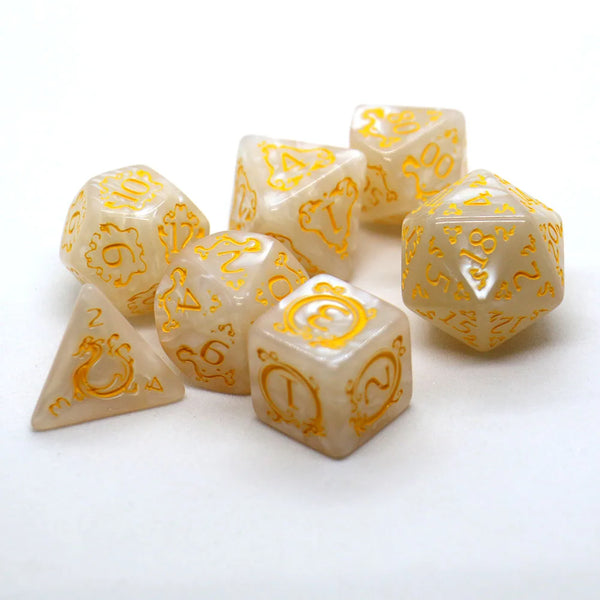 A collection of translucent yellow dragon dice, ranging from D4 to D20, are scattered on a white surface.