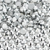 A close-up view of small, silver glass crystal flatback rhinestones scattered on a white background.