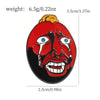 A red enamel lapel pin depicting a demonic face with glowing blue eyes and dripping blood.