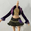 A fashion doll wearing a purple velvet jacket, gold top, and a dark green skirt with purple accents.