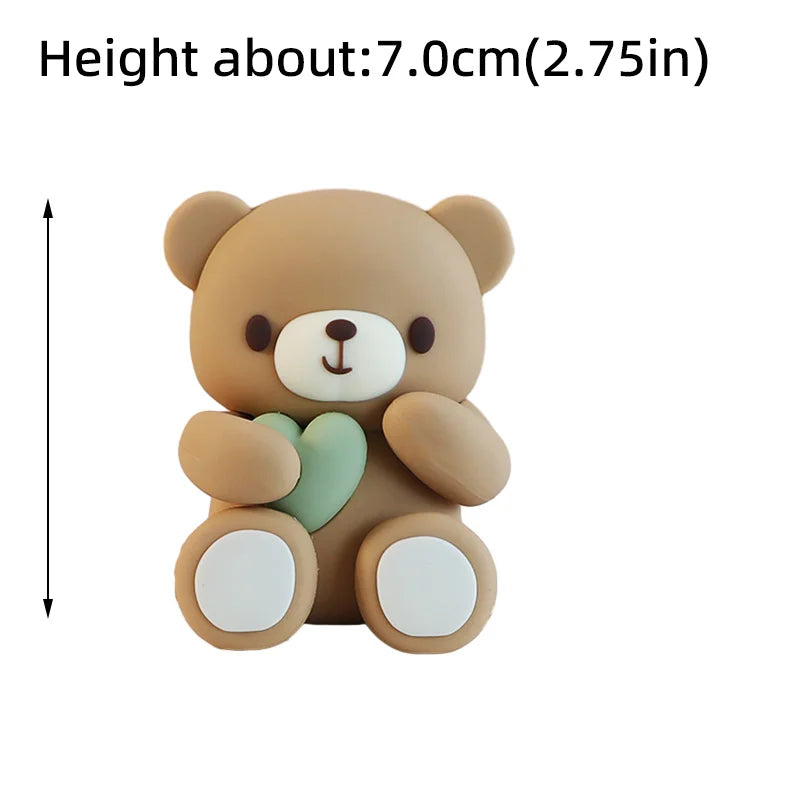 A light brown 3D bear cake topper with a green heart detail.