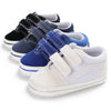 A row of blue and gray canvas baby sneakers for infants, showing various colors and styles.