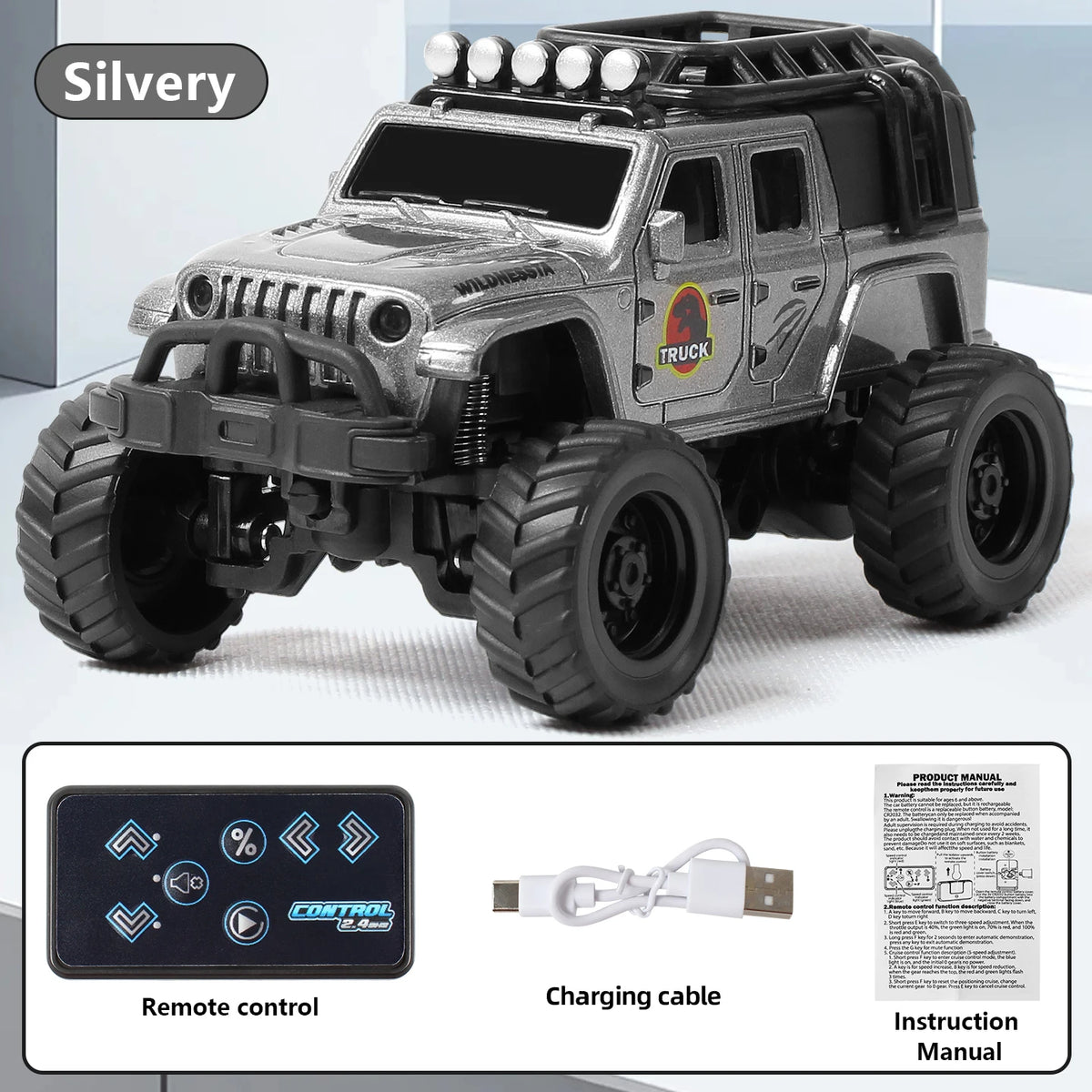 A silver off-road RC truck model with large tires and a remote control and charging cable.