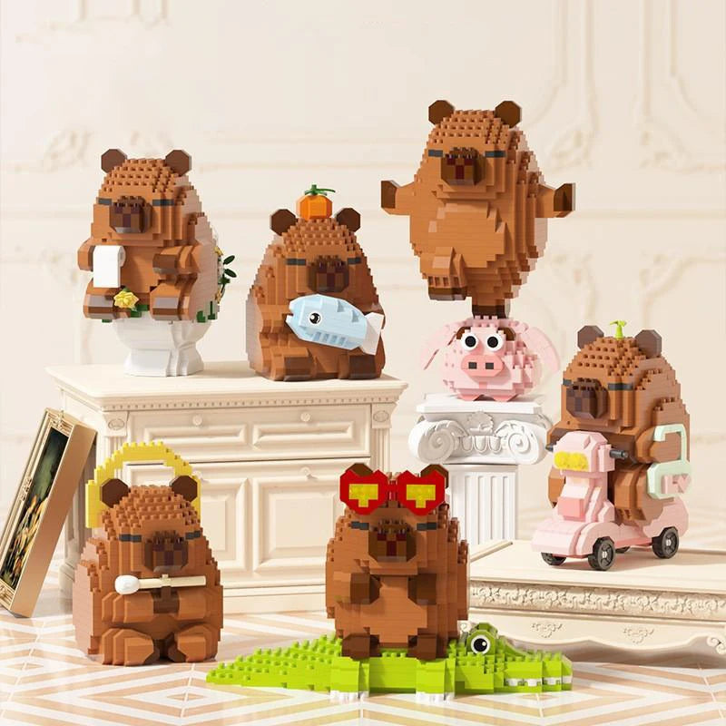 A collection of cute capybara-themed micro building blocks in various shades of brown and pink.