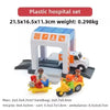 Plastic hospital set with a toy ambulance and medical supplies on a wooden train track.