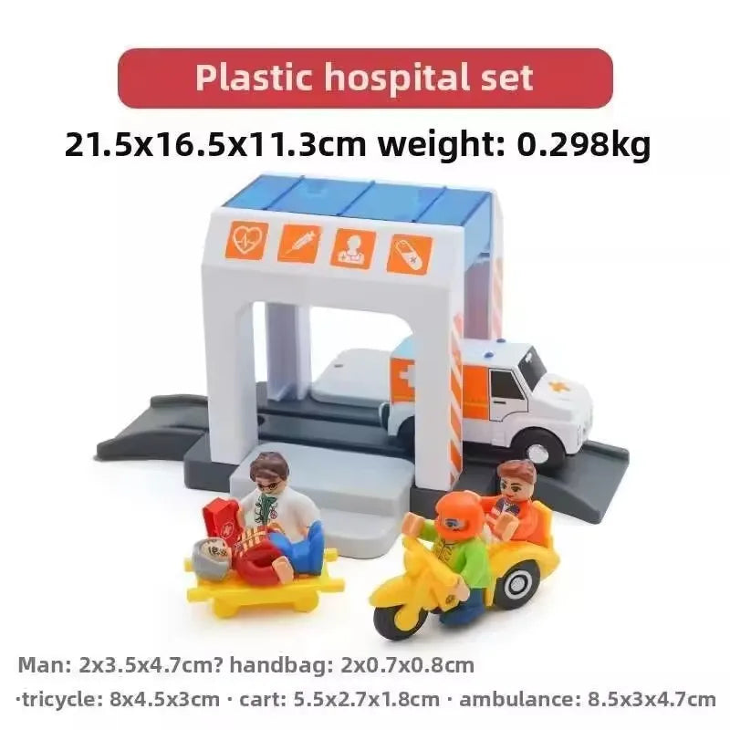 Plastic hospital set with a toy ambulance and medical supplies on a wooden train track.