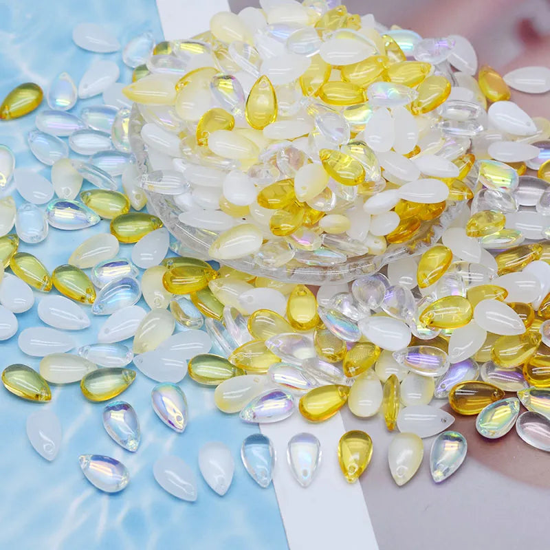 A pile of clear and yellow water drop Czech glass beads for jewelry making