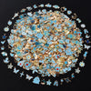 A circular arrangement of assorted metal pendants and charms in shades of blue, gold, and silver.