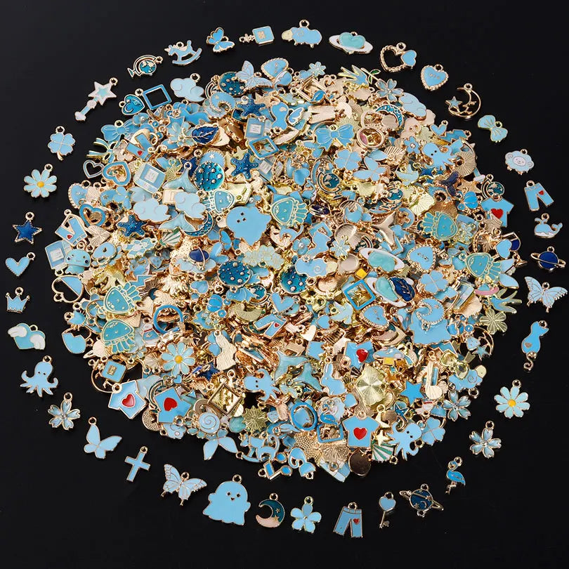 A circular arrangement of assorted metal pendants and charms in shades of blue, gold, and silver.