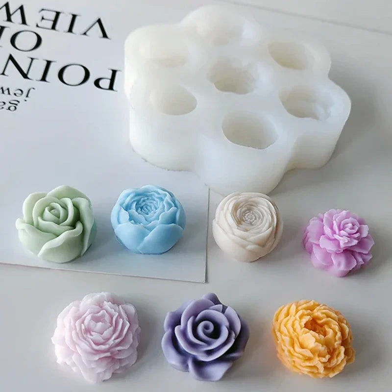 A set of pink and purple silicone molds shaped like roses for crafting and making