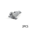A pair of gray ocean animal building blocks, resembling seals or sea creatures.
