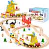 A wooden train set featuring a yellow construction crane, various trains, and a city scene on a curved track.