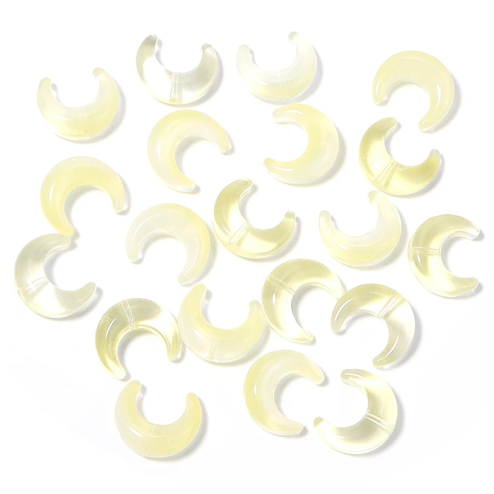 A collection of translucent yellow moon-shaped glass beads for DIY jewelry making.