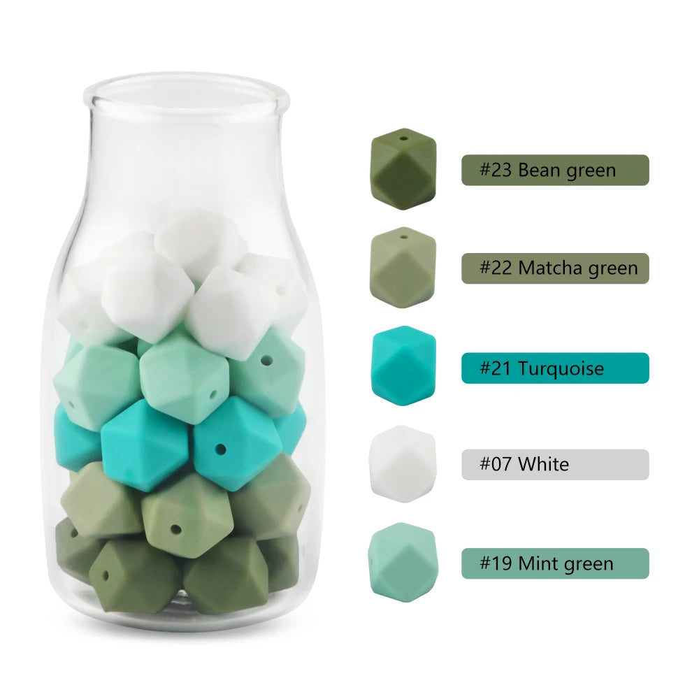 A clear glass jar filled with various hexagonal silicone beads in shades of green and blue, accompanied by a color chart.
