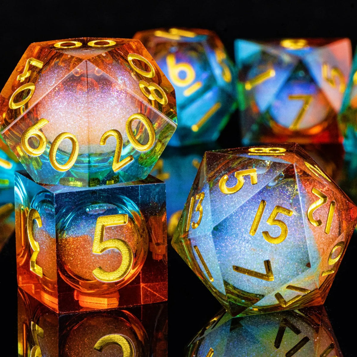 A set of polyhedral dice with a galaxy finish, showing various colors and angles on a reflective surface.