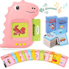 A pink dinosaur-shaped interactive flash card learning machine with various colorful cards and a bus toy.