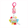 A plush owl hanging rattle toy with a pink and white striped ribbon and a pink ring.