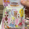 A plastic bag containing eight Sylvanian Families collectible figures in various colors and outfits.