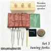 A set of three wooden tuning forks for sound healing and meditation, displayed next to a wooden box.
