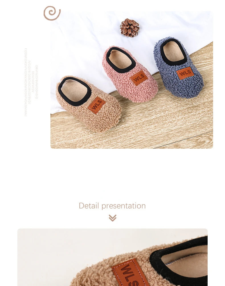 Three pairs of cozy plush baby slippers in beige, pink, and gray with anti-slip soles displayed on a wooden surface.
