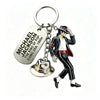 A silver keychain featuring a figure of Michael Jackson in a suit and hat.