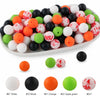 A platter filled with various colored silicone beads including white, black, orange, green, and red for crafts and jewelry.
