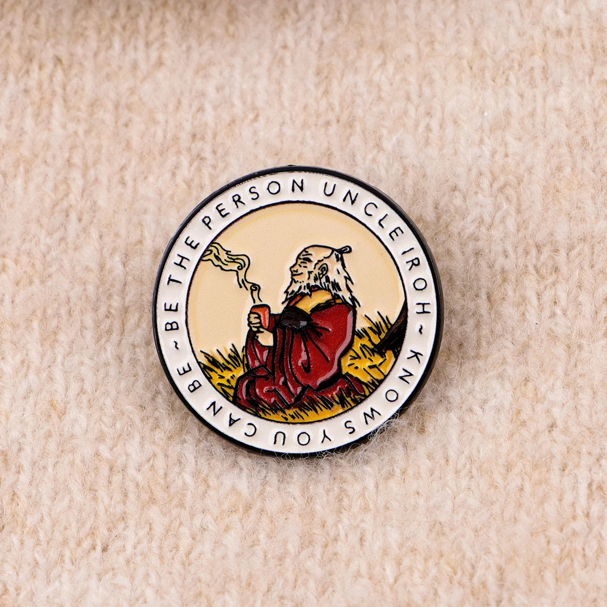 An enamel pin featuring a depiction of a bear with a beard and text surrounding it.