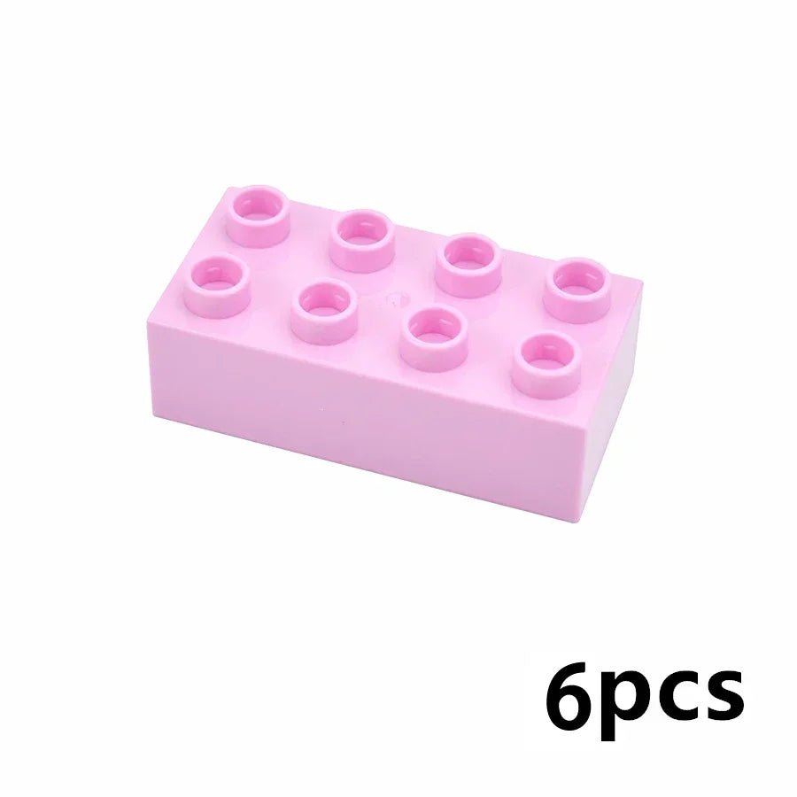 Un bloc de construction en plastique rose avec six chevilles circulaires sur le dessus, montrant six pièces individuelles.