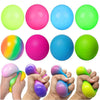 A collection of brightly colored stress relief balls in neon green, pink, and blue, shown being held by hands.