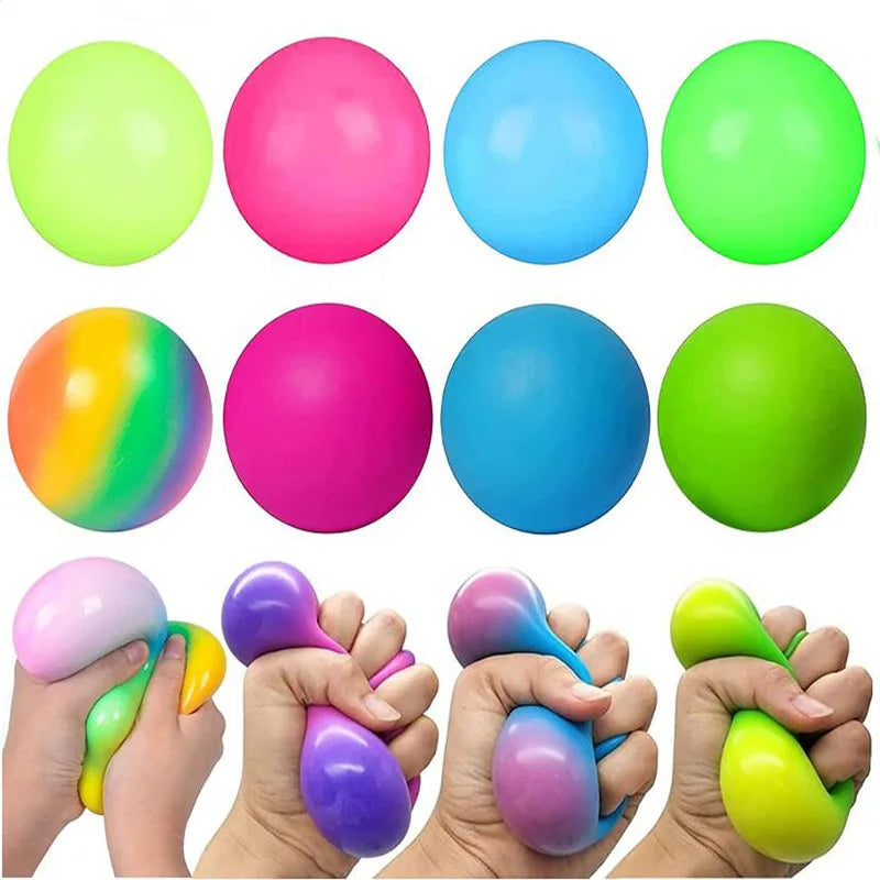 A collection of brightly colored stress relief balls in neon green, pink, and blue, shown being held by hands.
