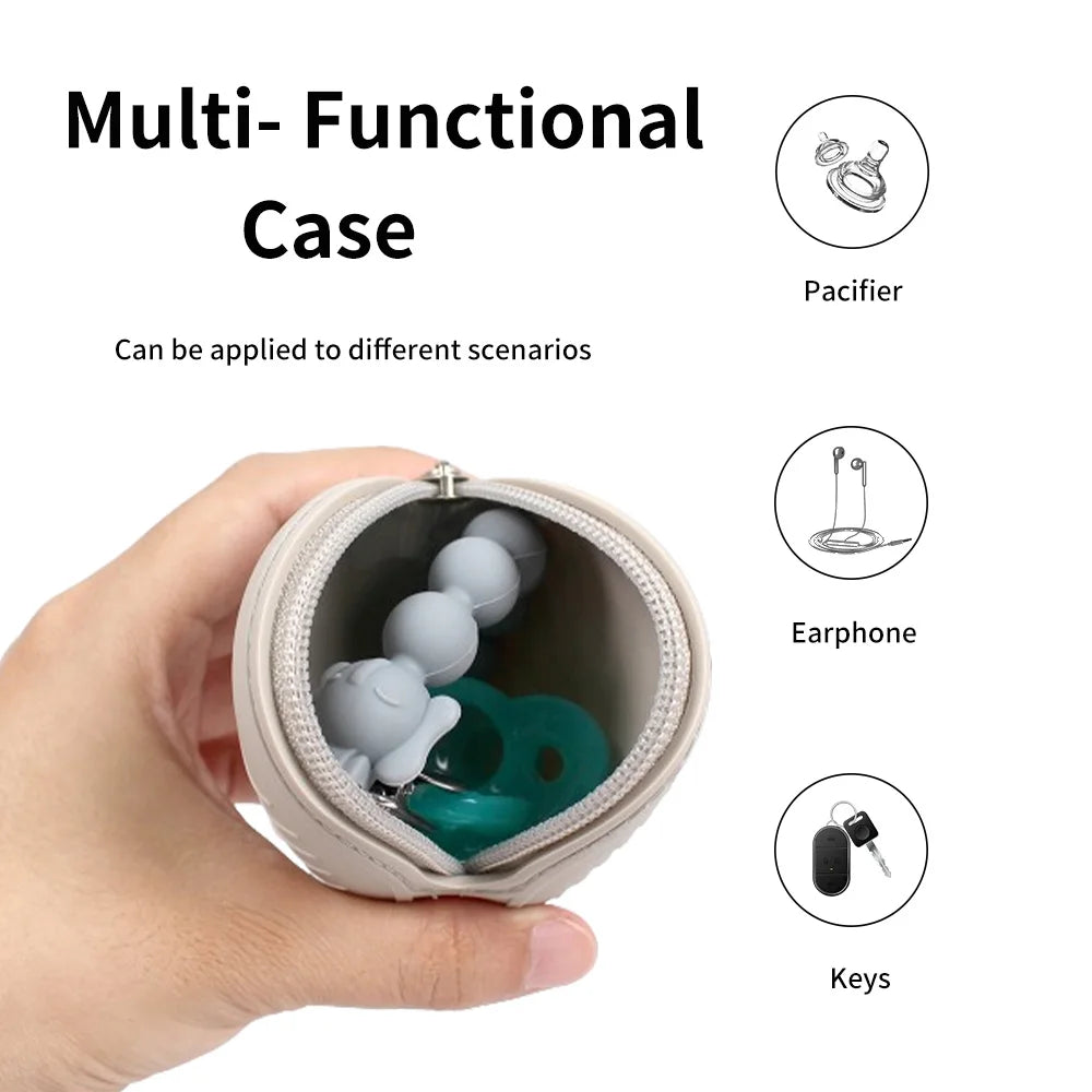 A light beige multi-functional silicone case is shown open, displaying compartments for a pacifier, an earphone, and keys.