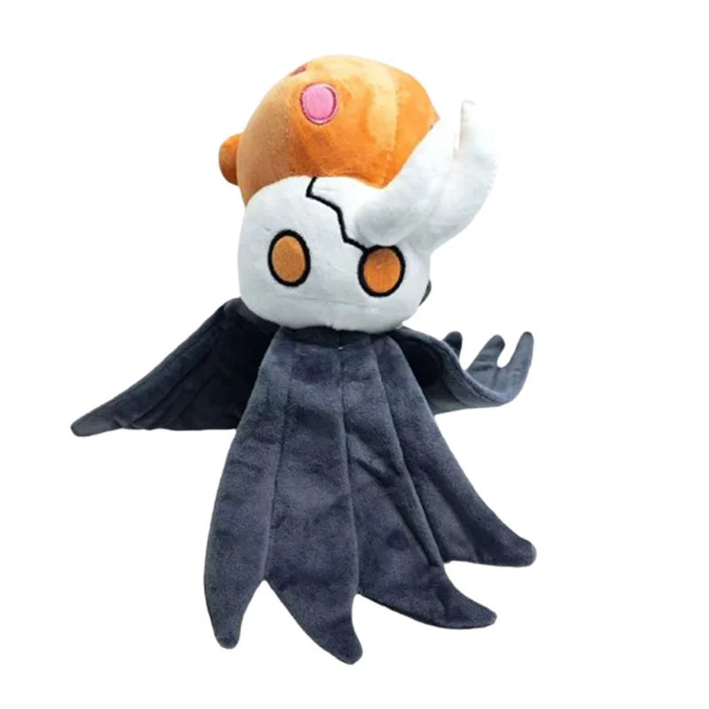 A plush doll resembling a white, horned creature with an orange head and dark gray wings.
