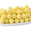 A row of round, pale yellow silicone beads for jewelry making and DIY crafts.