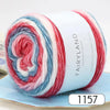 A roll of gradient rainbow yarn showing red, white, and blue fibers for knitting and crochet projects.