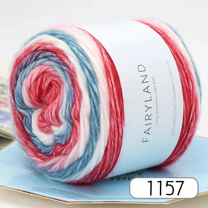 A roll of gradient rainbow yarn showing red, white, and blue fibers for knitting and crochet projects.