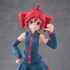 A PVC figure of Hatsune Miku with red hair and a blue outfit, posed with one hand raised.