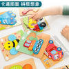 A hand is placing a piece of a wooden animal and traffic puzzle into a corresponding slot on another puzzle board.