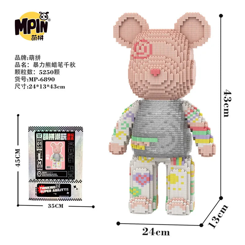 A small bear figure made of pink and gray micro building blocks with a gray shirt and yellow pants.