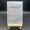 A vertical box of cute pink and blue stickers labeled LE ZHI Stickers displayed on a wooden stand.